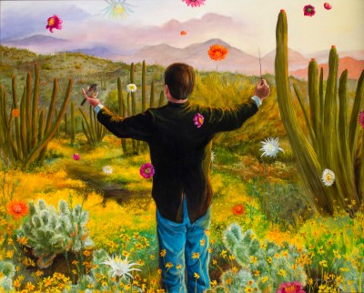 A man in a tuxedo jacket and blue pants seen from behind, standing in front of a field of cacti and flowers. He holds a bird in one hand and a baton in the other. Flowers rain down before mountains in the distance.