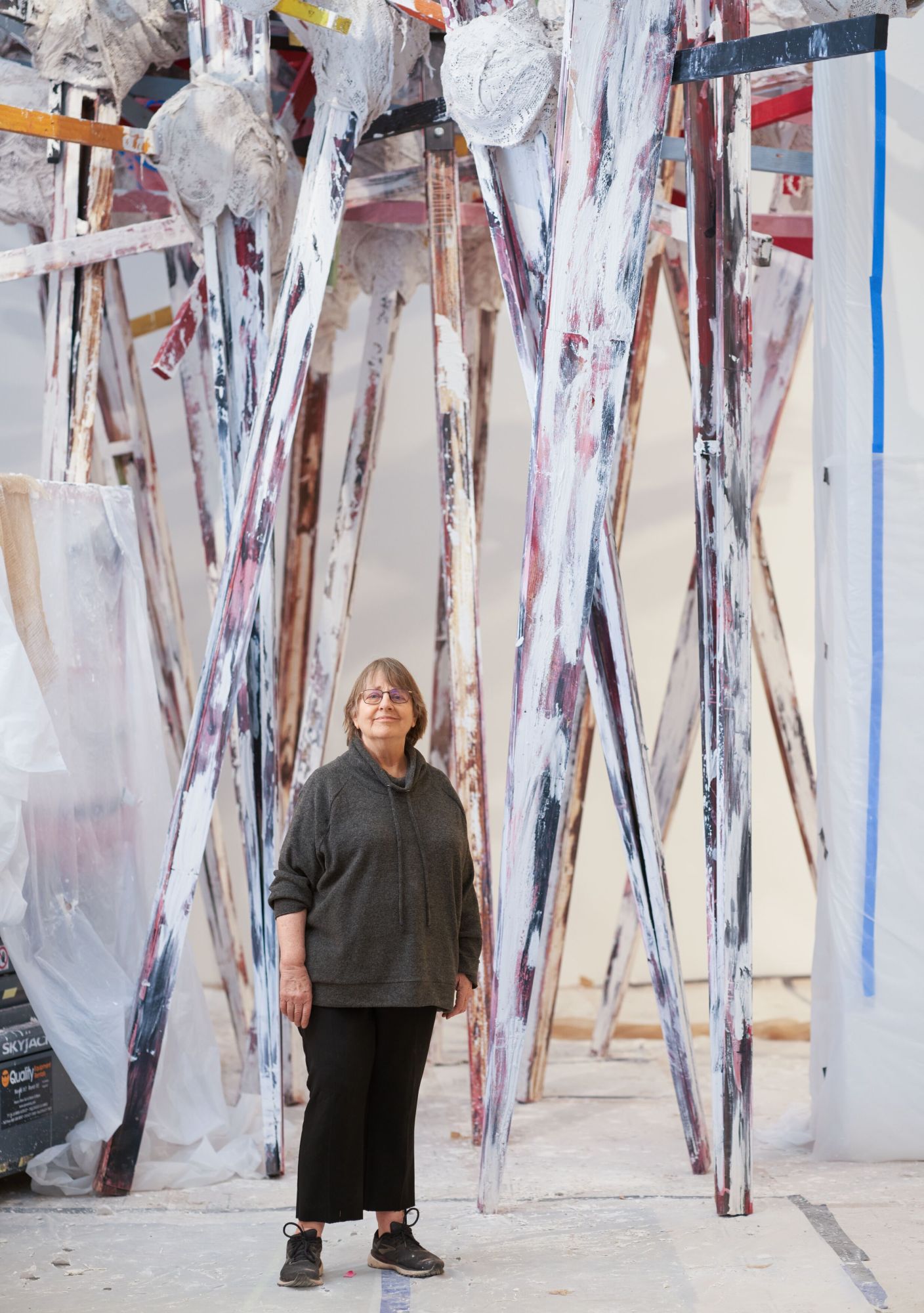 Portrait of Phyllida Barlow in 2022, in front of a sculpture in progress in her studio.