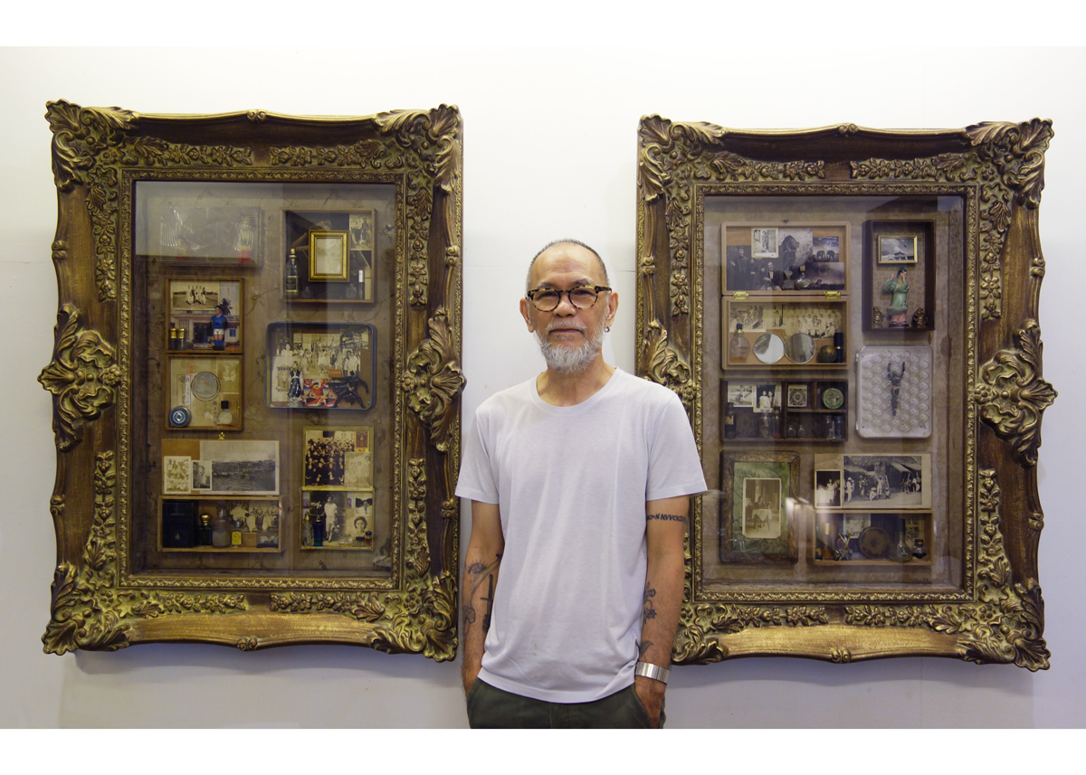 Artist Norberto Roldan stands in front of his two altar artworks.