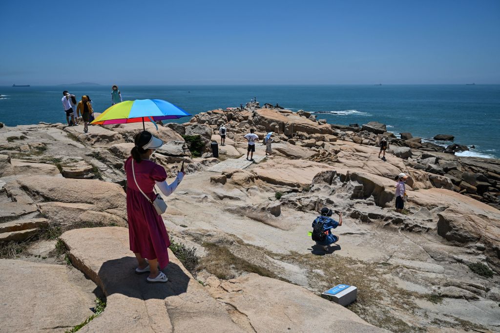 Tourists in a scenic area of Pingtan Island, one of mainland China's closest point from Taiwan, in Fujian province, 2022.