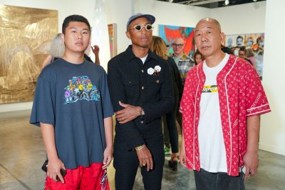 MIAMI BEACH, FLORIDA - NOVEMBER 29: Carson Guo, Pharrell Williams and Bob Guo attend the 2022 ABMB Art Fair Preview on November 29, 2022 in Miami Beach, Florida. (Photo by Sean Zanni/Patrick McMullan via Getty Images)