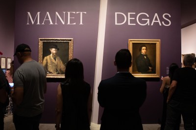 Portraits of two men beneath text reading 'MANET' and 'DEGAS' in different fonts. A giant slash runs between the two.