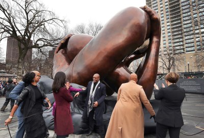 Boston, MA - January 13: The Embrace statue is unveiled as artist Hank Willis Thomas, center rear, stands next to it while Boston Mayor Michelle Wu, Congresswoman Ayanna Pressley, and Governor Maura Healey pull the ropes. (Photo John Tlumacki/The Boston Globe via Getty Images)