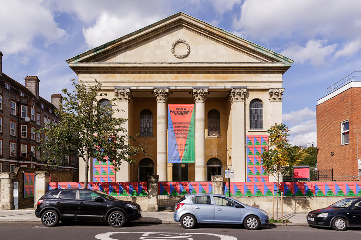 A museum with a banner between its columns.